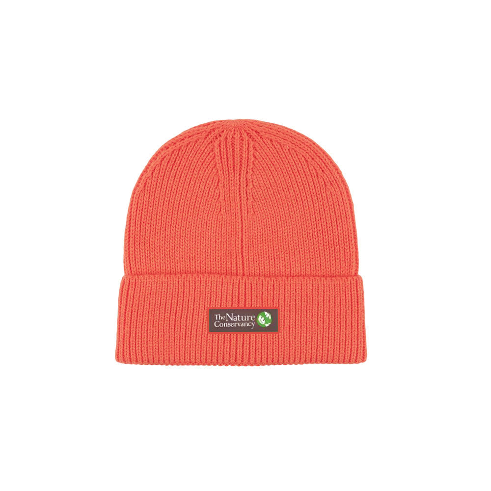 A pink/red hue ribbed beanie with a woven twill label displaying a logo.
